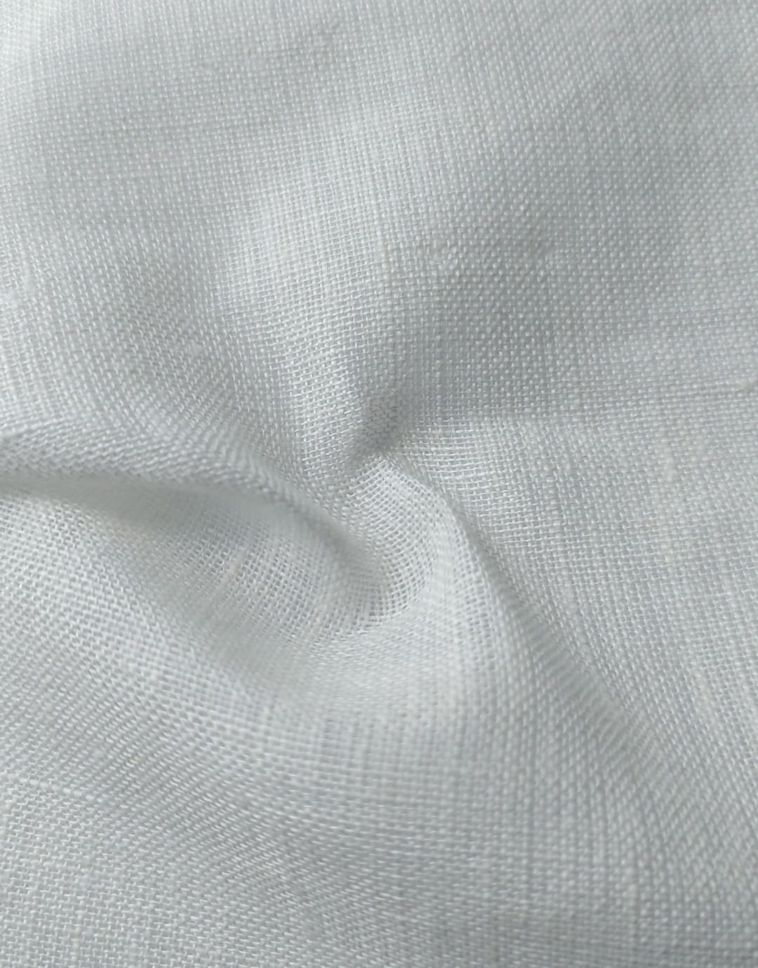 Close-up of soft, wrinkled pink cotton fabric displaying fine weave texture.