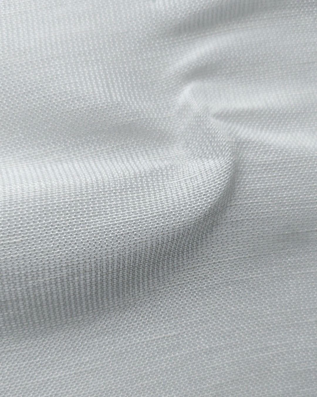Close-up of soft, wrinkled pink cotton fabric displaying fine weave texture.