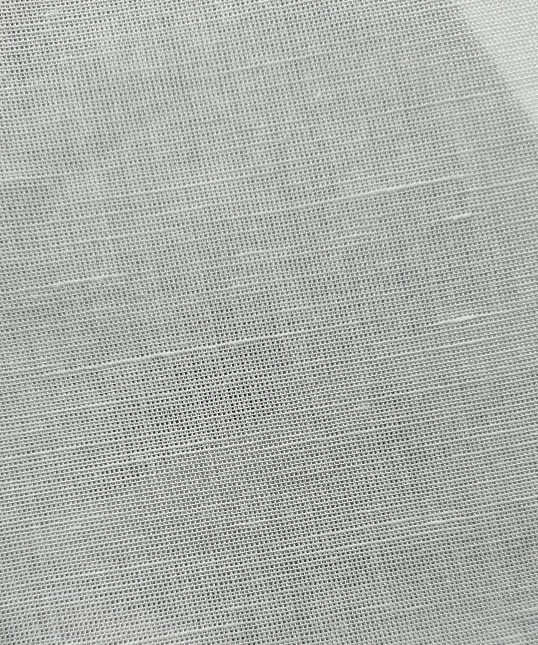 Close-up of soft, wrinkled pink cotton fabric displaying fine weave texture.