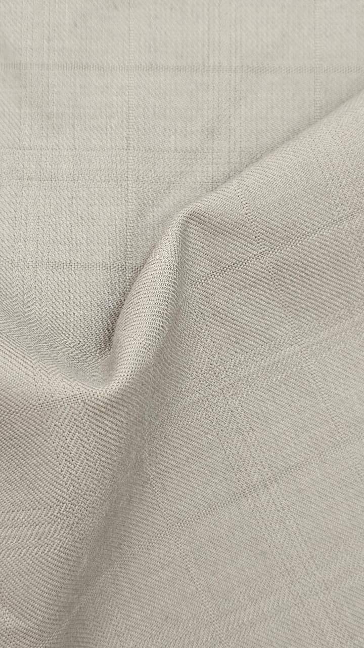 Close-up of soft, wrinkled pink cotton fabric displaying fine weave texture.