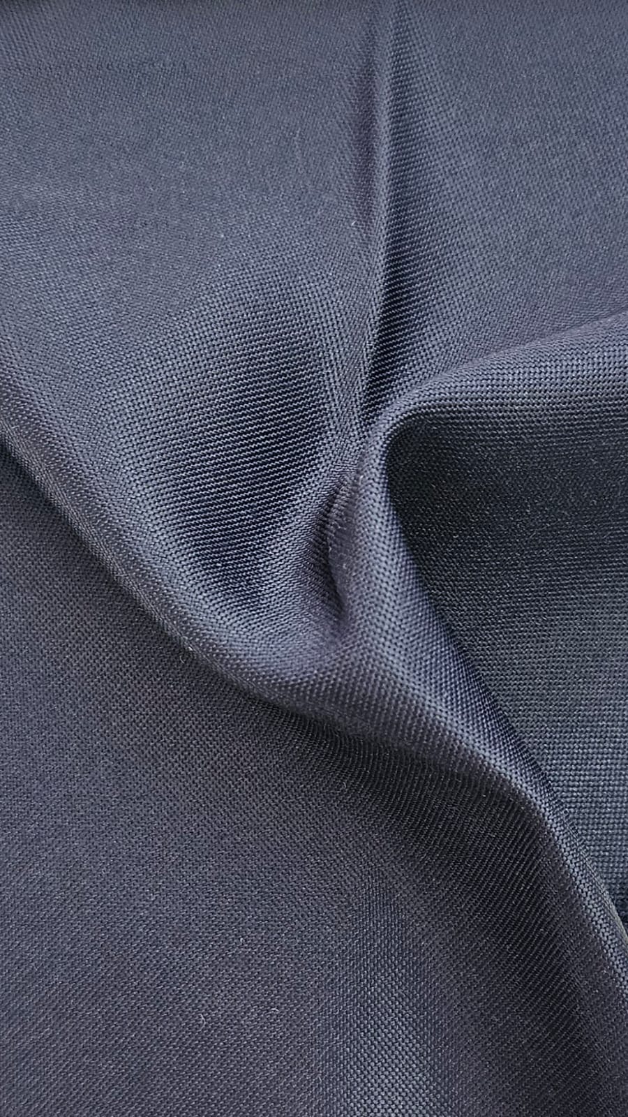 Close-up of soft, wrinkled pink cotton fabric displaying fine weave texture.
