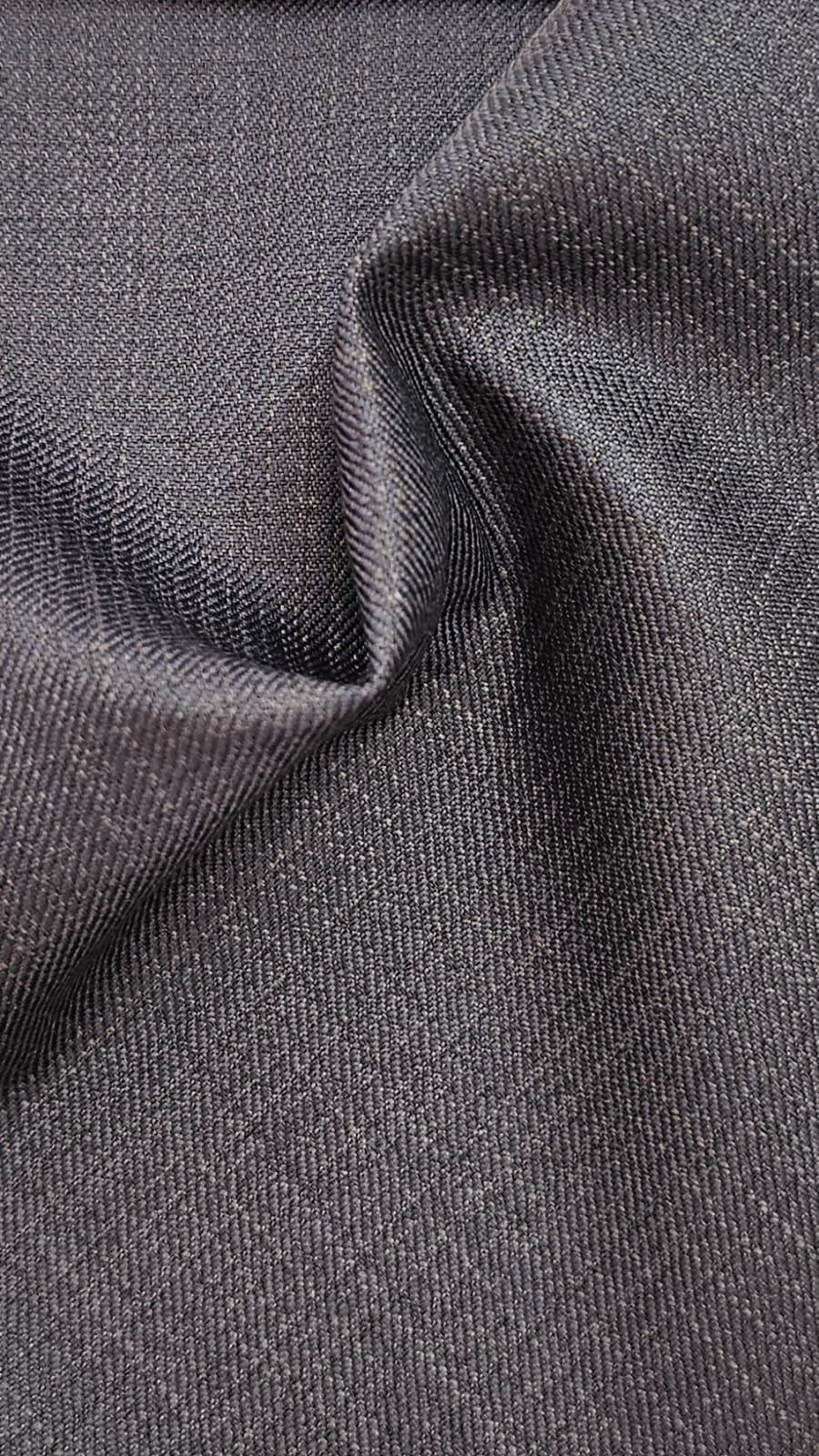 Close-up of soft, wrinkled pink cotton fabric displaying fine weave texture.