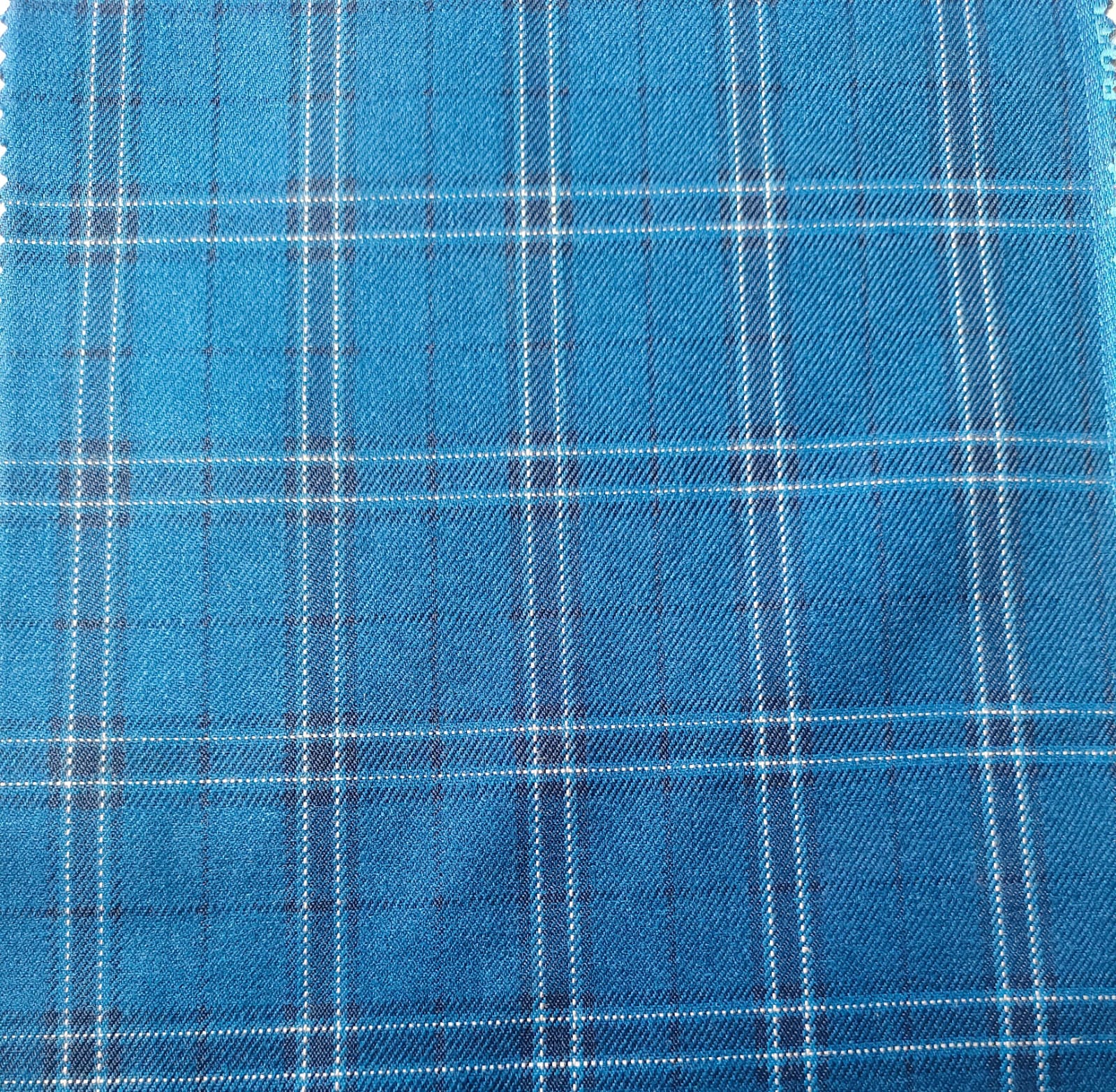 Close-up of soft, wrinkled pink cotton fabric displaying fine weave texture.