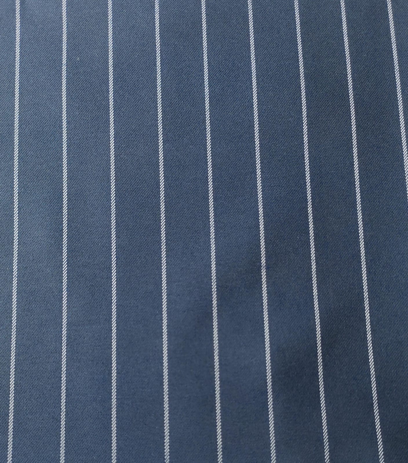 Close-up of soft, wrinkled pink cotton fabric displaying fine weave texture.