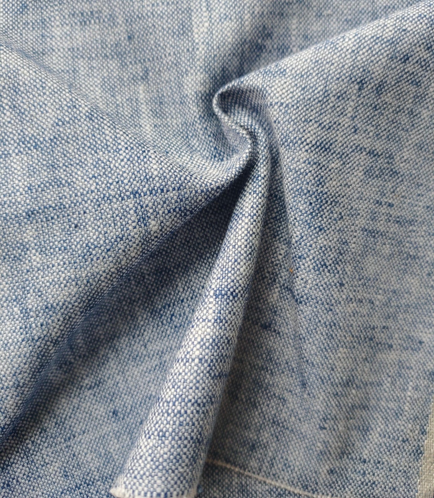 Close-up of soft, wrinkled pink cotton fabric displaying fine weave texture.