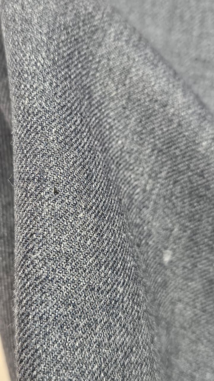 Close-up of soft, wrinkled pink cotton fabric displaying fine weave texture.