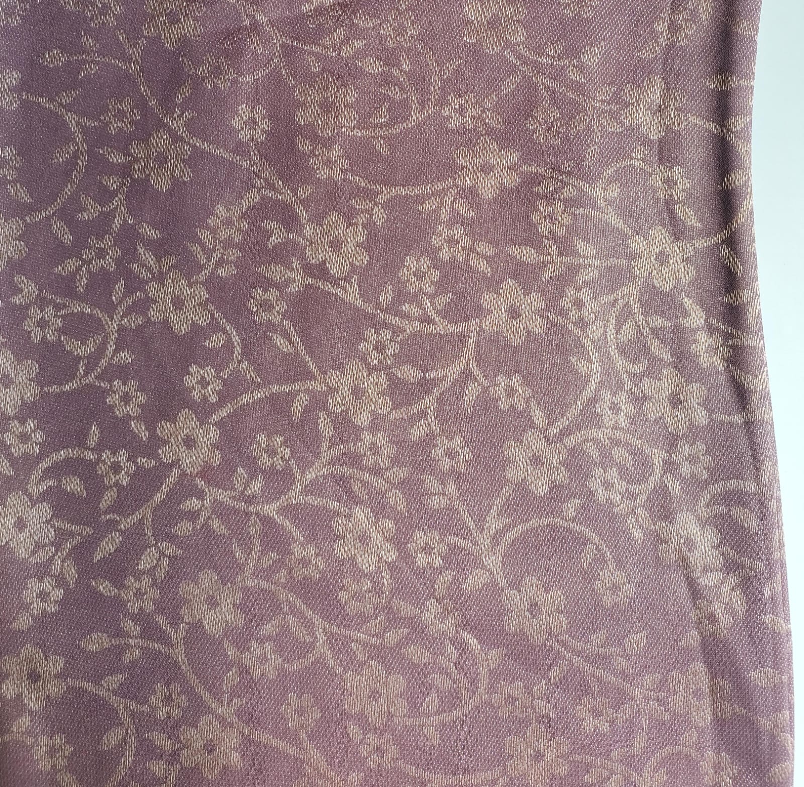 Close-up of soft, wrinkled pink cotton fabric displaying fine weave texture.