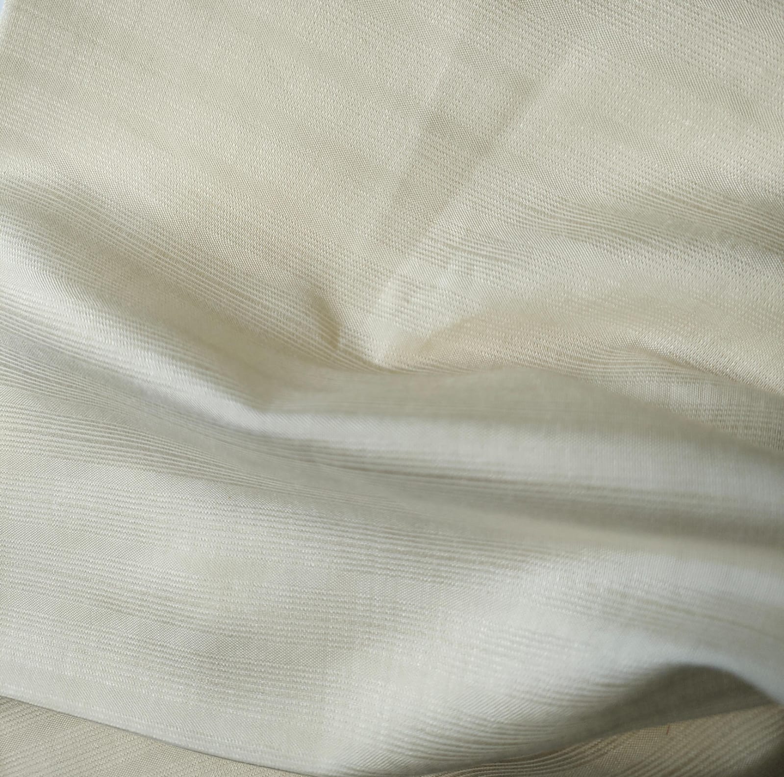 Close-up of soft, wrinkled pink cotton fabric displaying fine weave texture.