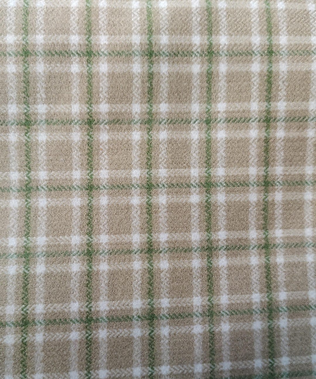Close-up of soft, wrinkled pink cotton fabric displaying fine weave texture.