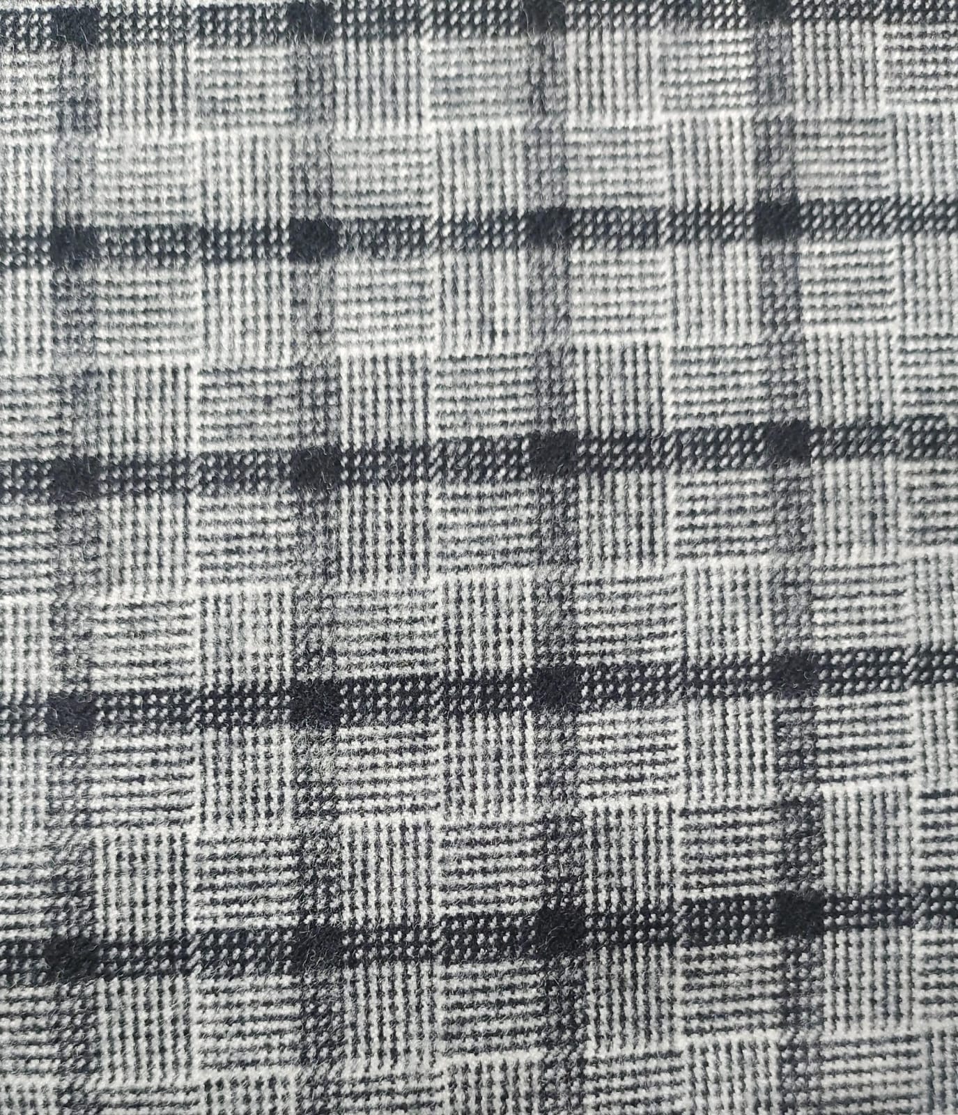 Close-up of soft, wrinkled pink cotton fabric displaying fine weave texture.