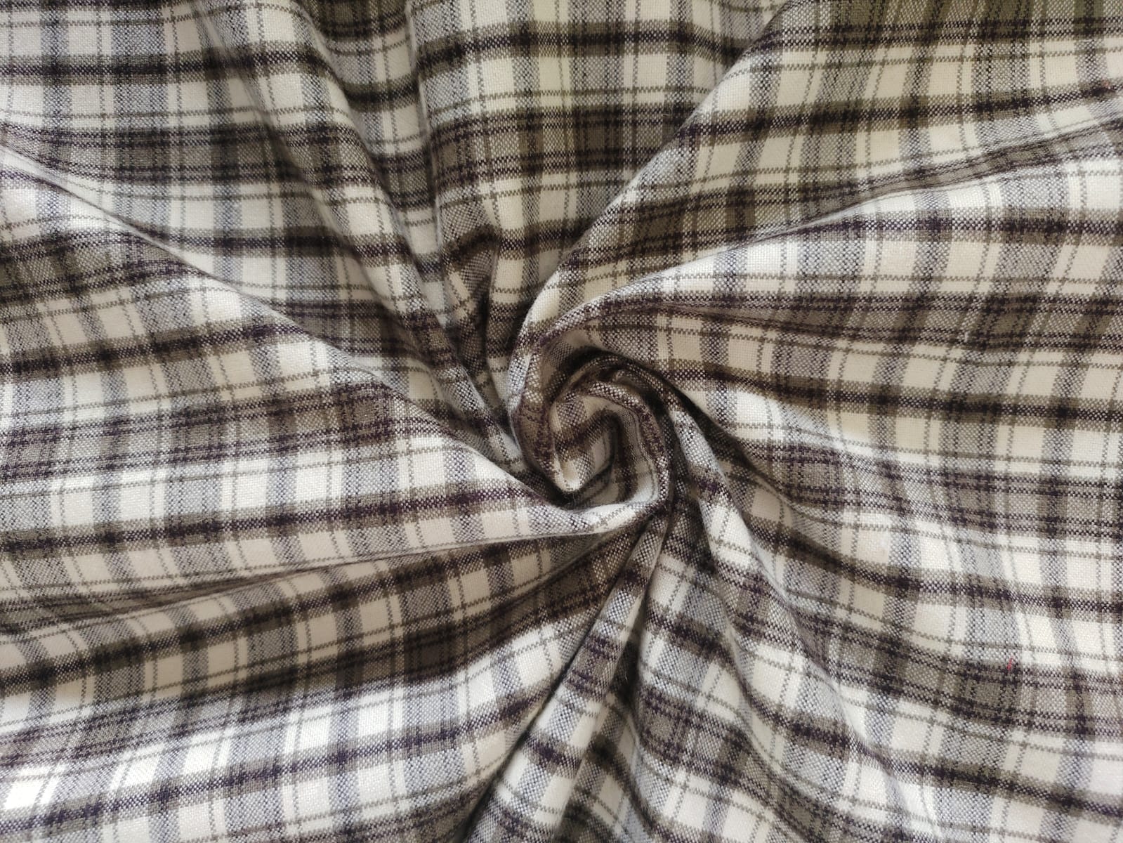 Close-up of soft, wrinkled pink cotton fabric displaying fine weave texture.