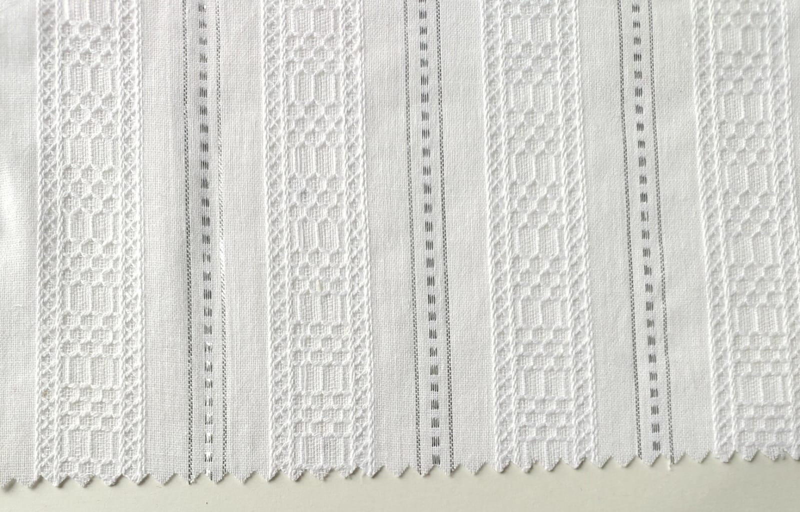 Close-up of soft, wrinkled pink cotton fabric displaying fine weave texture.