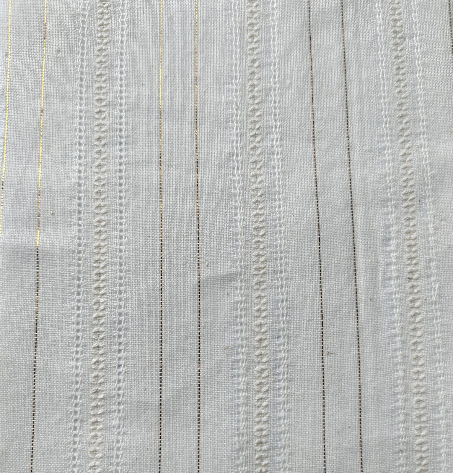 Close-up of soft, wrinkled pink cotton fabric displaying fine weave texture.