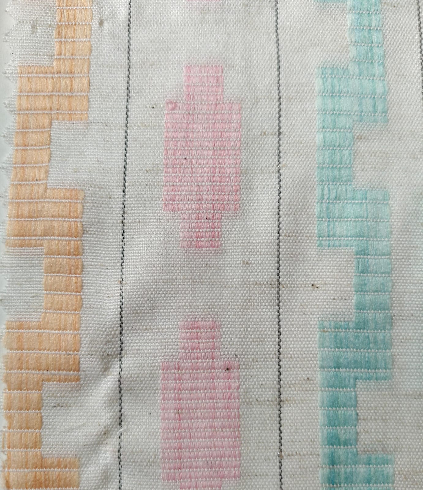 Close-up of soft, wrinkled pink cotton fabric displaying fine weave texture.
