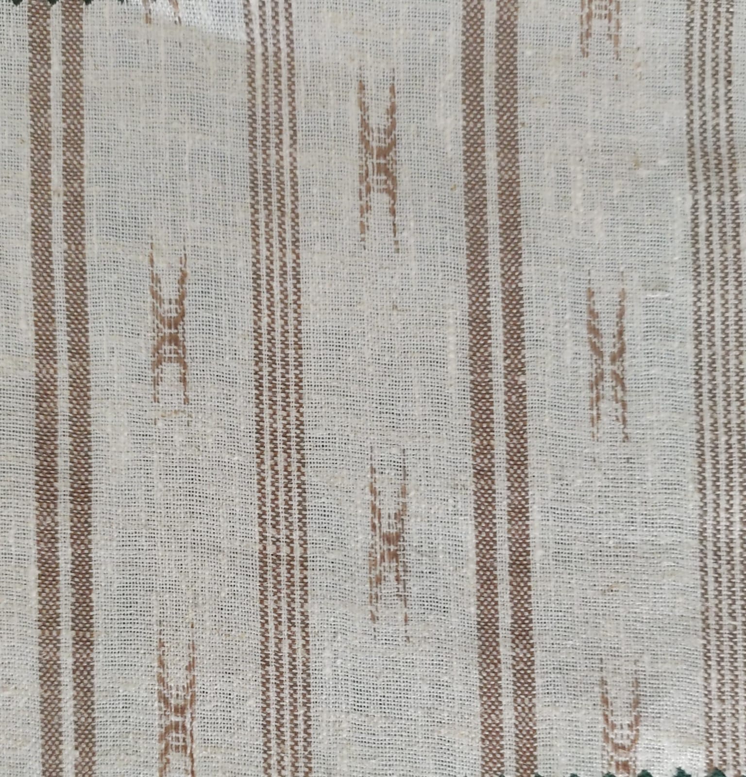 Close-up of soft, wrinkled pink cotton fabric displaying fine weave texture.