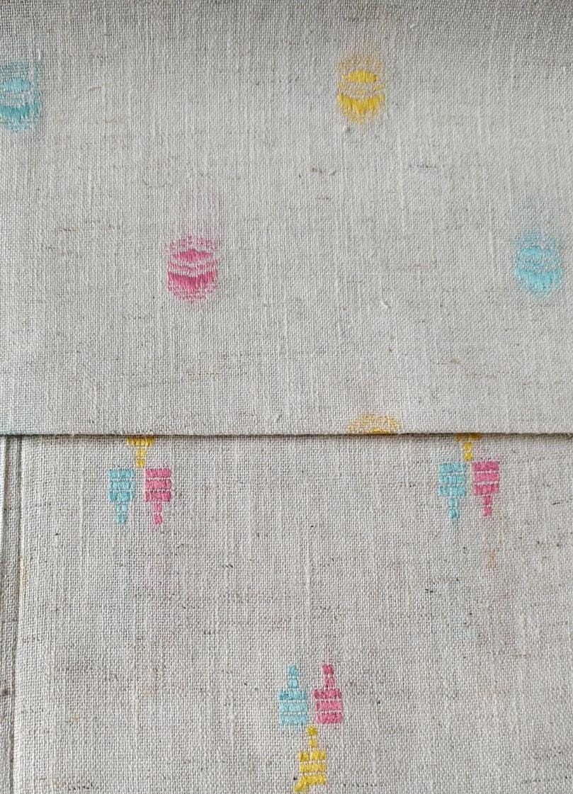 Close-up of soft, wrinkled pink cotton fabric displaying fine weave texture.