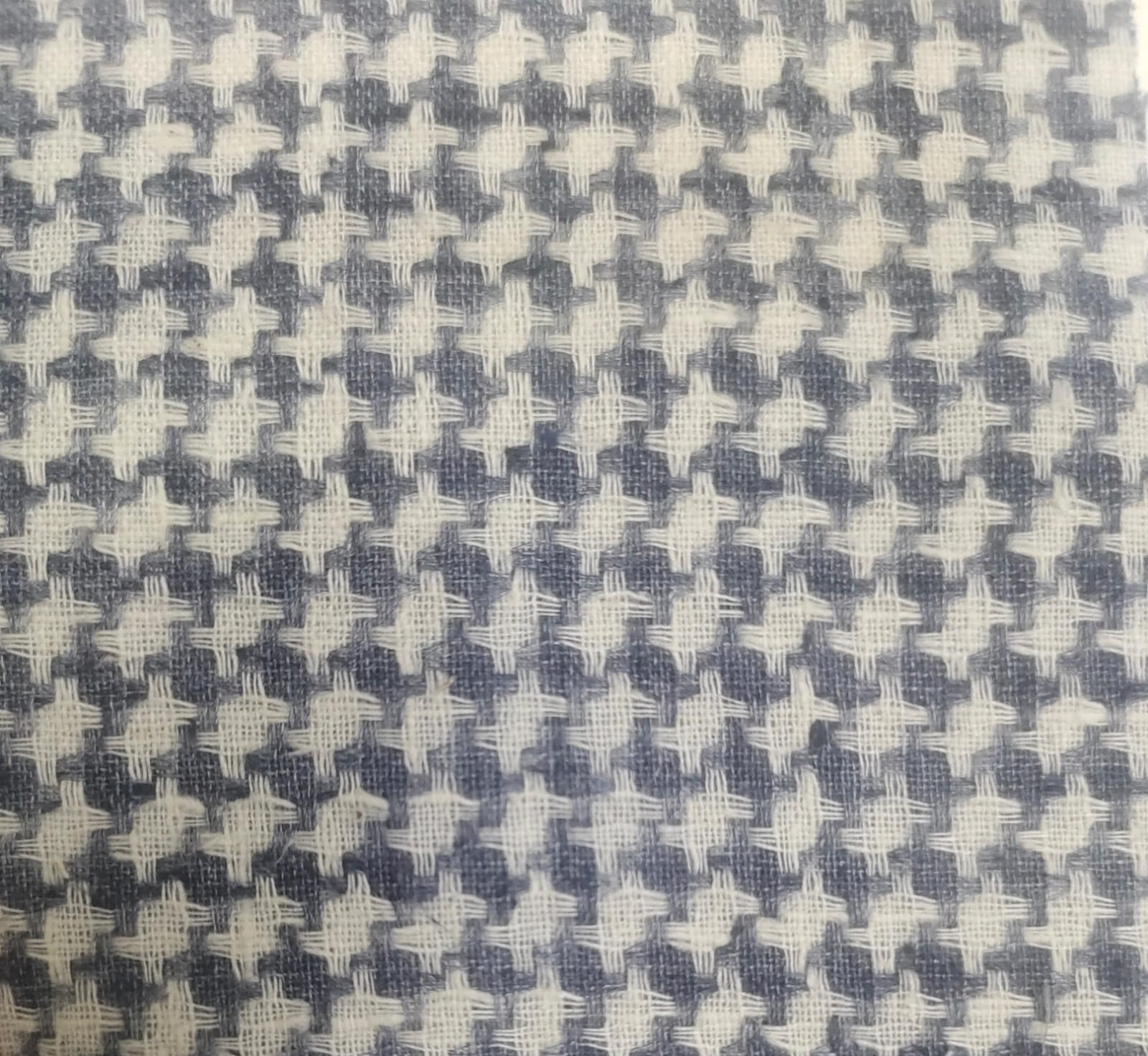 Close-up of soft, wrinkled pink cotton fabric displaying fine weave texture.