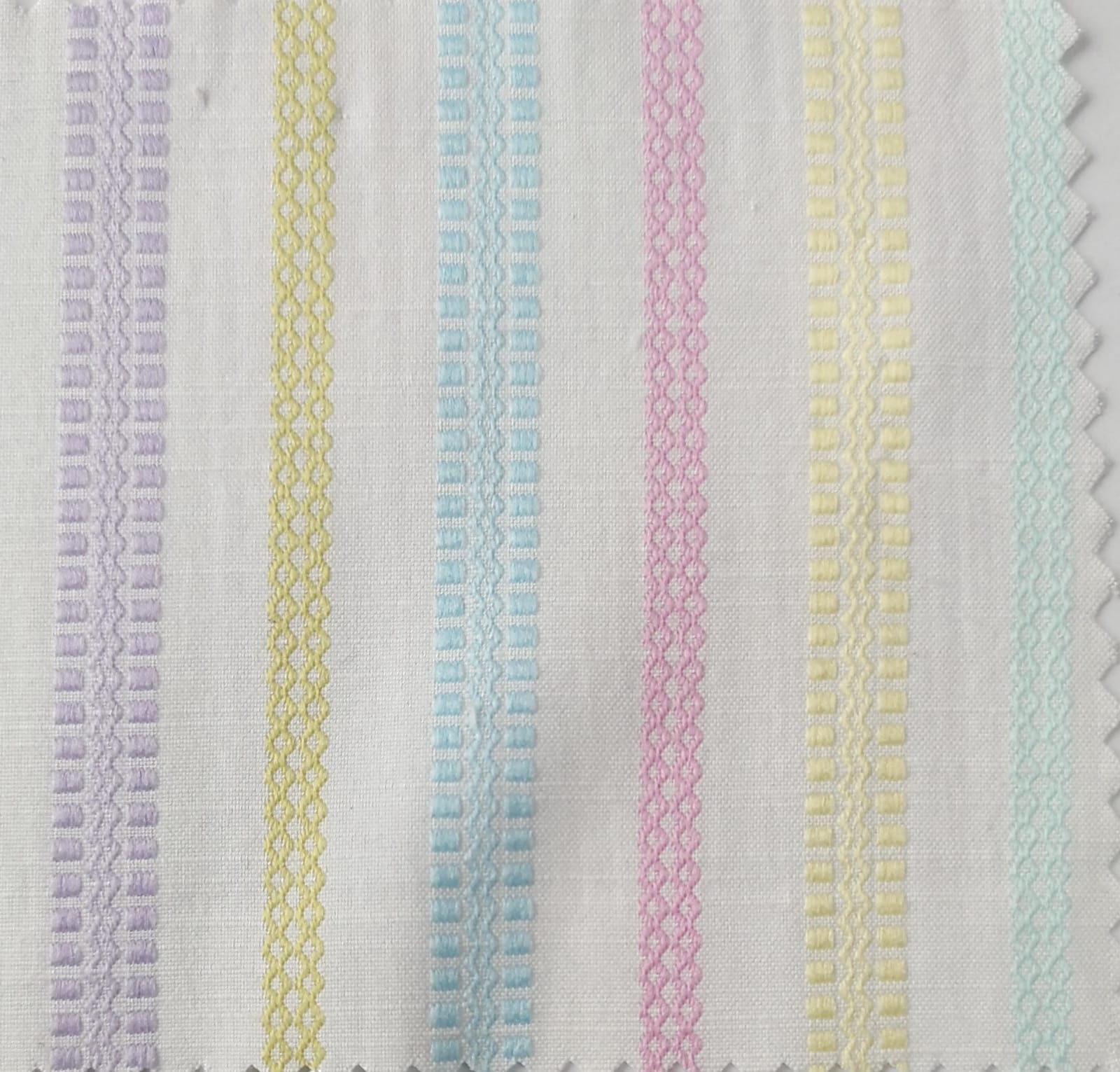 Close-up of soft, wrinkled pink cotton fabric displaying fine weave texture.