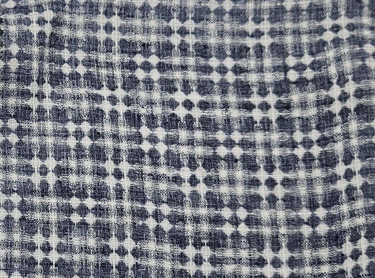Close-up of soft, wrinkled pink cotton fabric displaying fine weave texture.