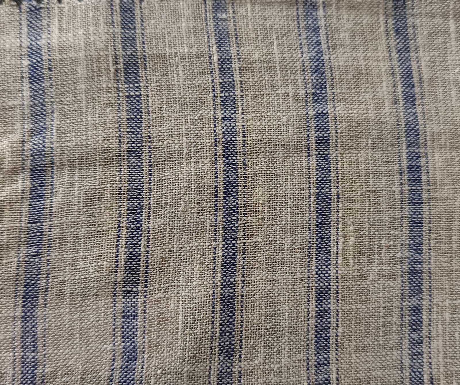 Close-up of soft, wrinkled pink cotton fabric displaying fine weave texture.