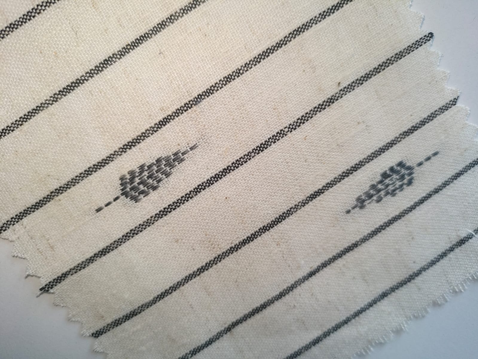 Close-up of soft, wrinkled pink cotton fabric displaying fine weave texture.