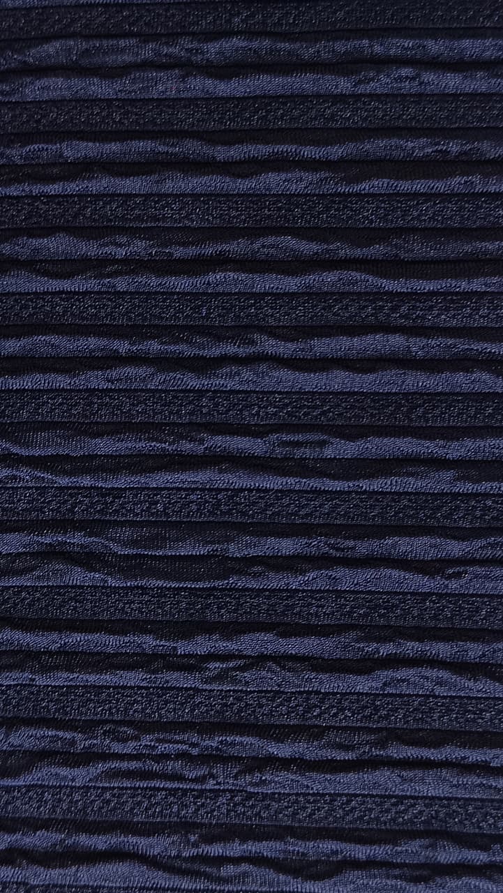 Close-up of soft, wrinkled pink cotton fabric displaying fine weave texture.