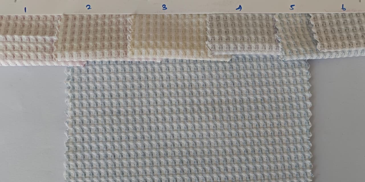 Close-up of soft, wrinkled pink cotton fabric displaying fine weave texture.
