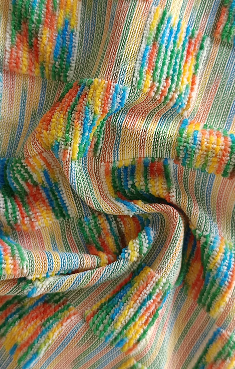 Close-up of soft, wrinkled pink cotton fabric displaying fine weave texture.