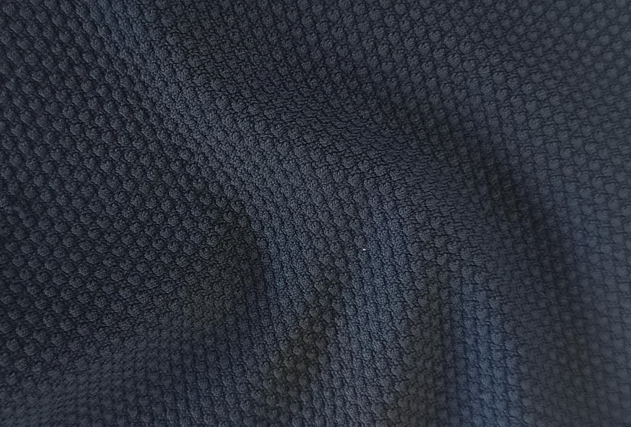 Close-up of soft, wrinkled pink cotton fabric displaying fine weave texture.