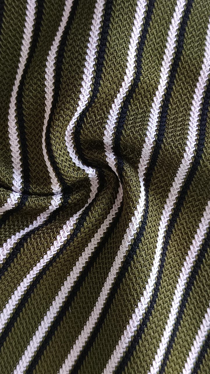 Close-up of soft, wrinkled pink cotton fabric displaying fine weave texture.