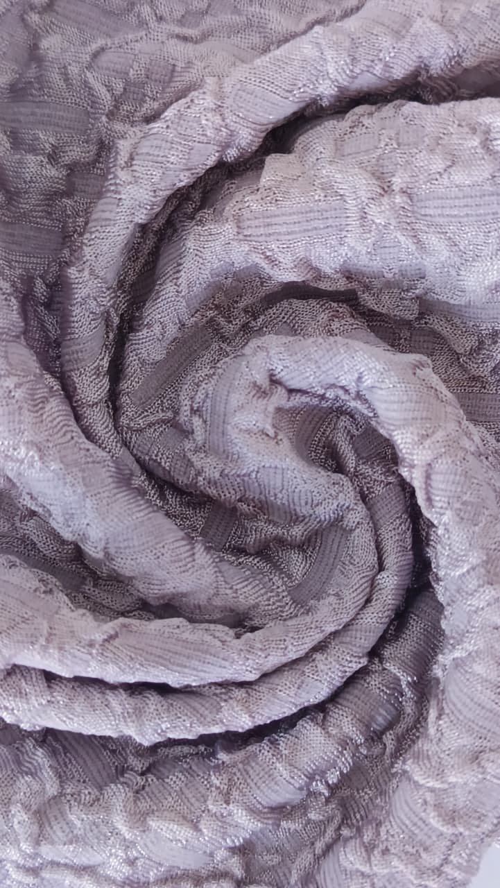 Close-up of soft, wrinkled pink cotton fabric displaying fine weave texture.