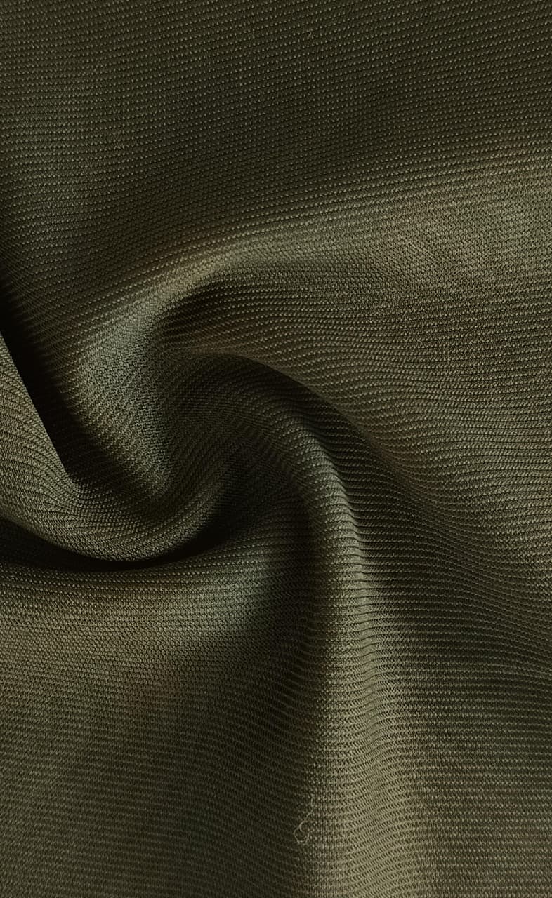 Close-up of soft, wrinkled pink cotton fabric displaying fine weave texture.