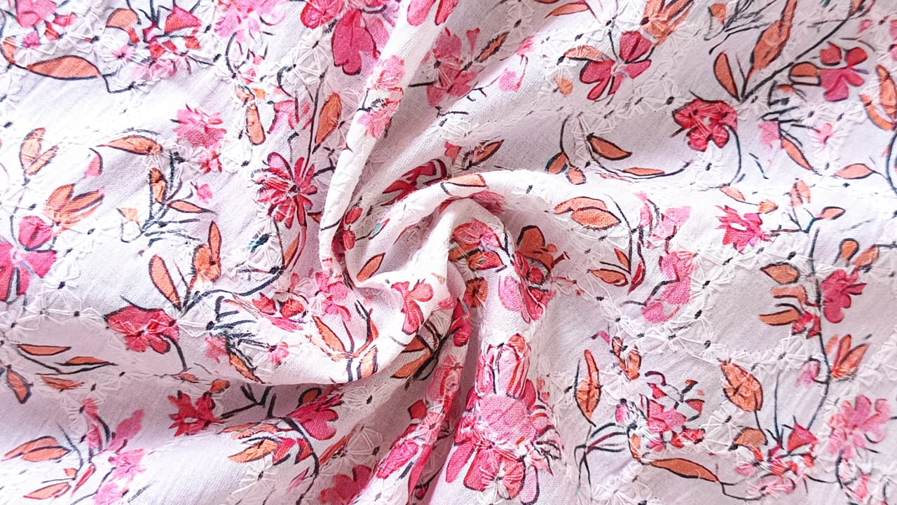 Close-up of soft, wrinkled pink cotton fabric displaying fine weave texture.