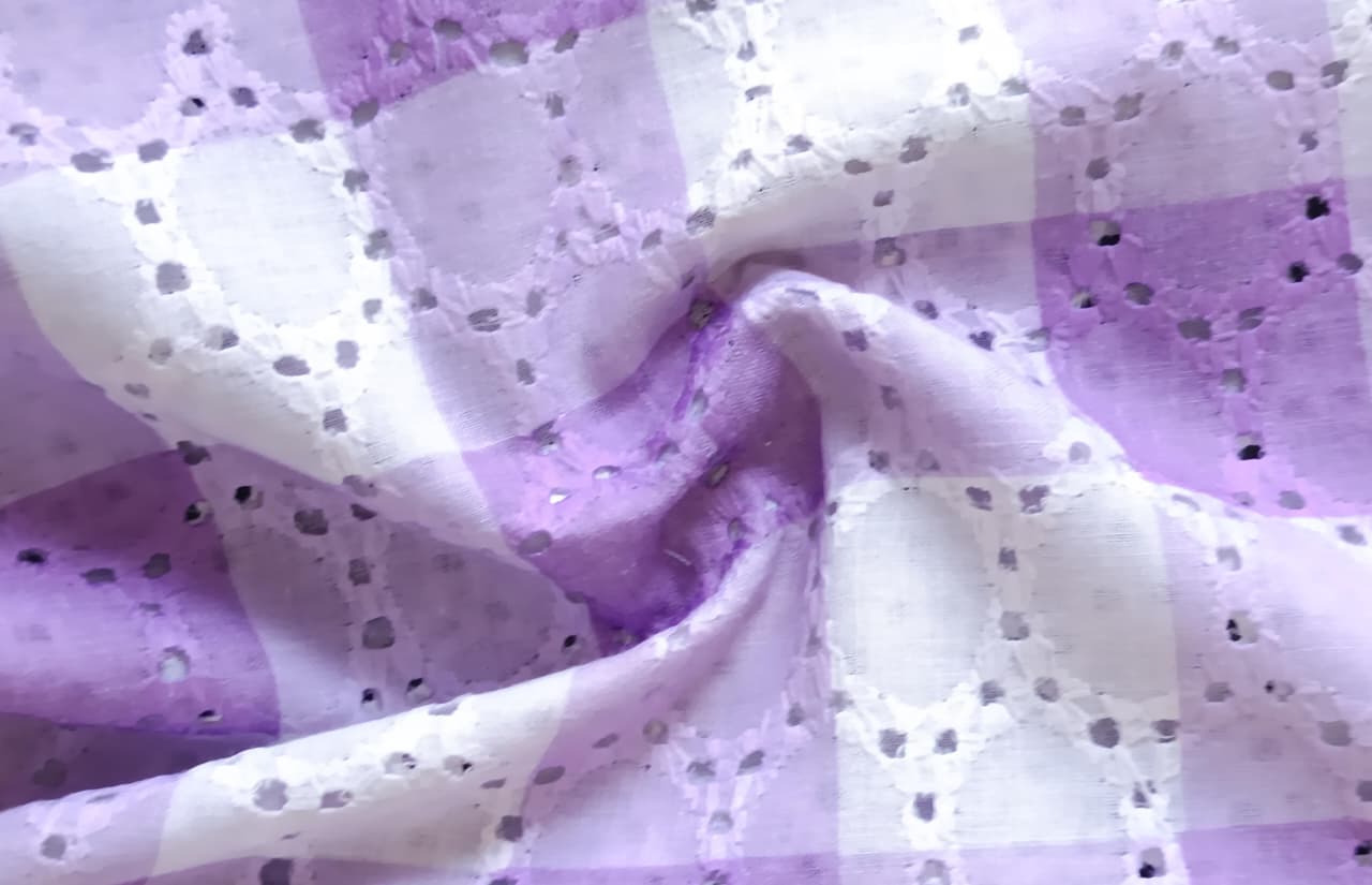 Close-up of soft, wrinkled pink cotton fabric displaying fine weave texture.