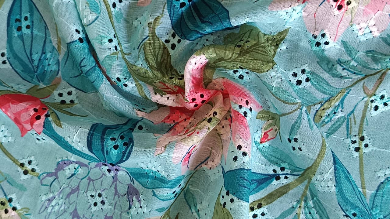 Close-up of soft, wrinkled pink cotton fabric displaying fine weave texture.