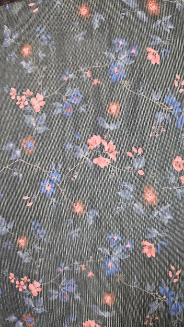 Close-up of soft, wrinkled pink cotton fabric displaying fine weave texture.