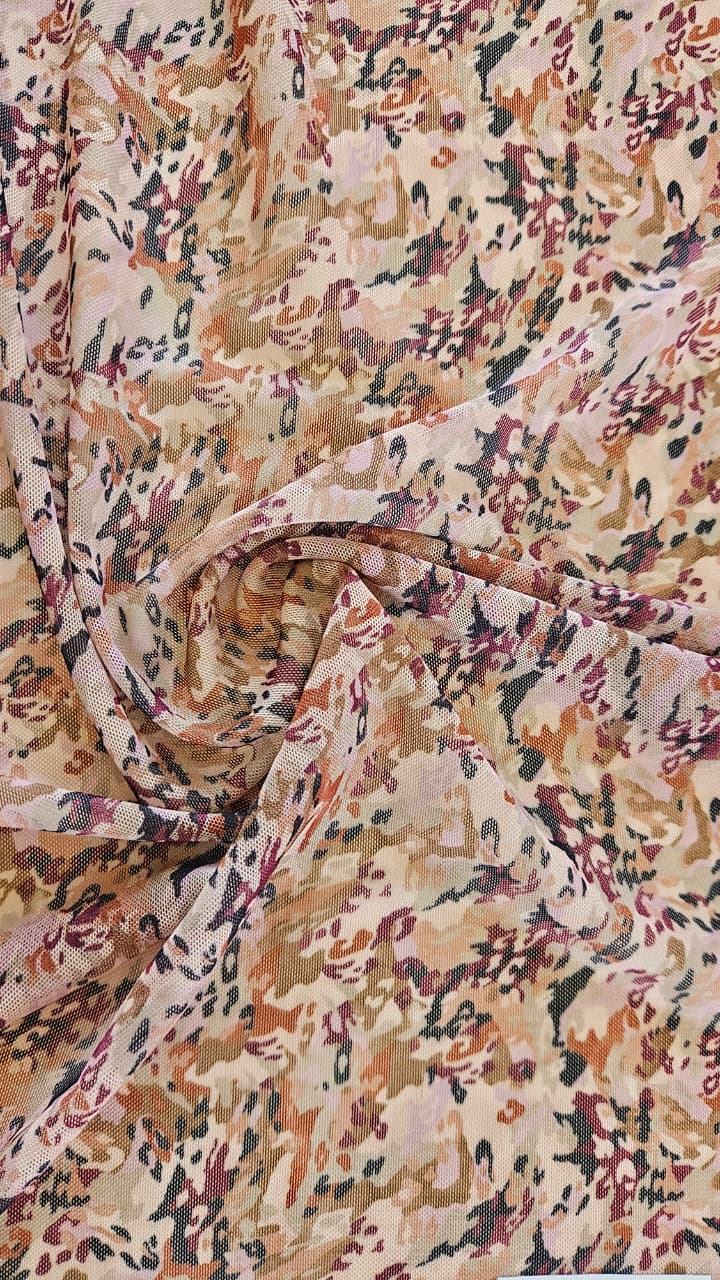 Close-up of soft, wrinkled pink cotton fabric displaying fine weave texture.