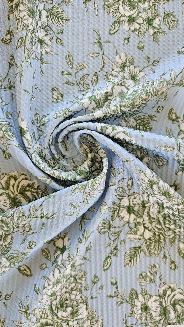 Close-up of soft, wrinkled pink cotton fabric displaying fine weave texture.