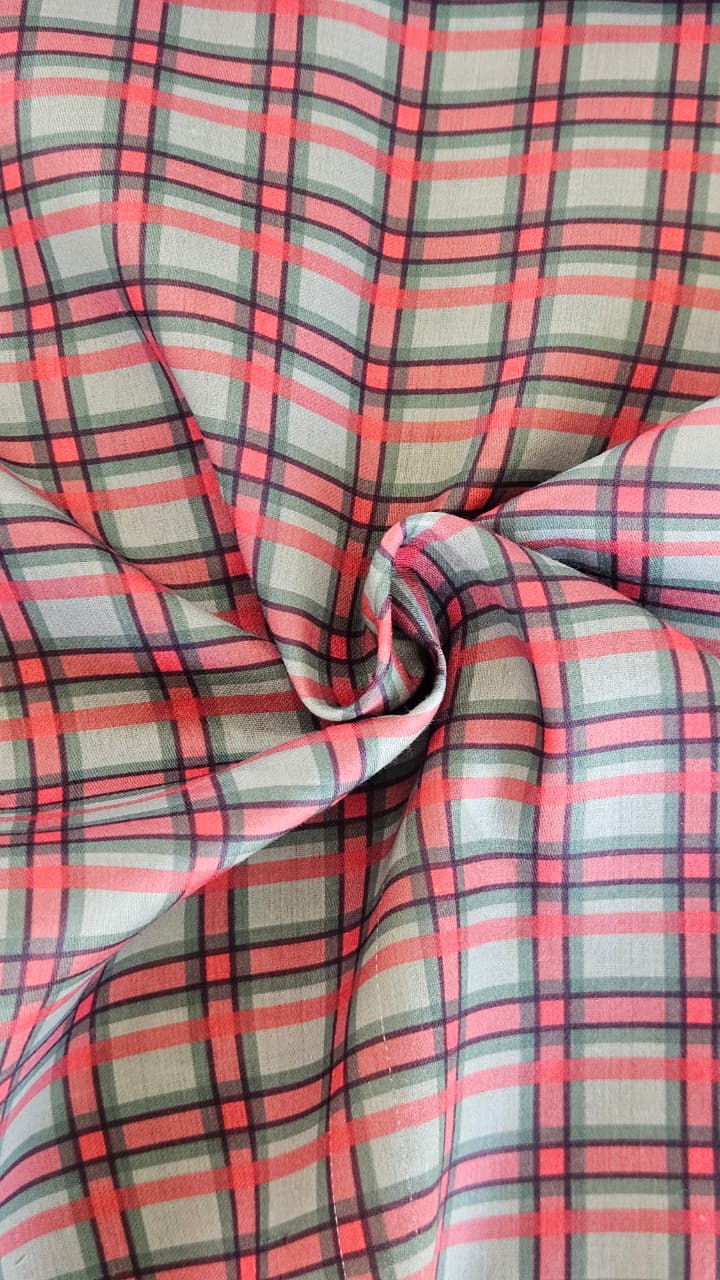 Close-up of soft, wrinkled pink cotton fabric displaying fine weave texture.