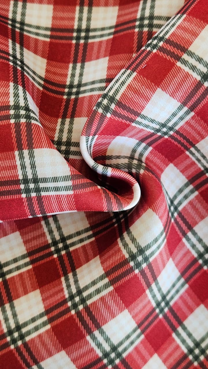 Close-up of soft, wrinkled pink cotton fabric displaying fine weave texture.