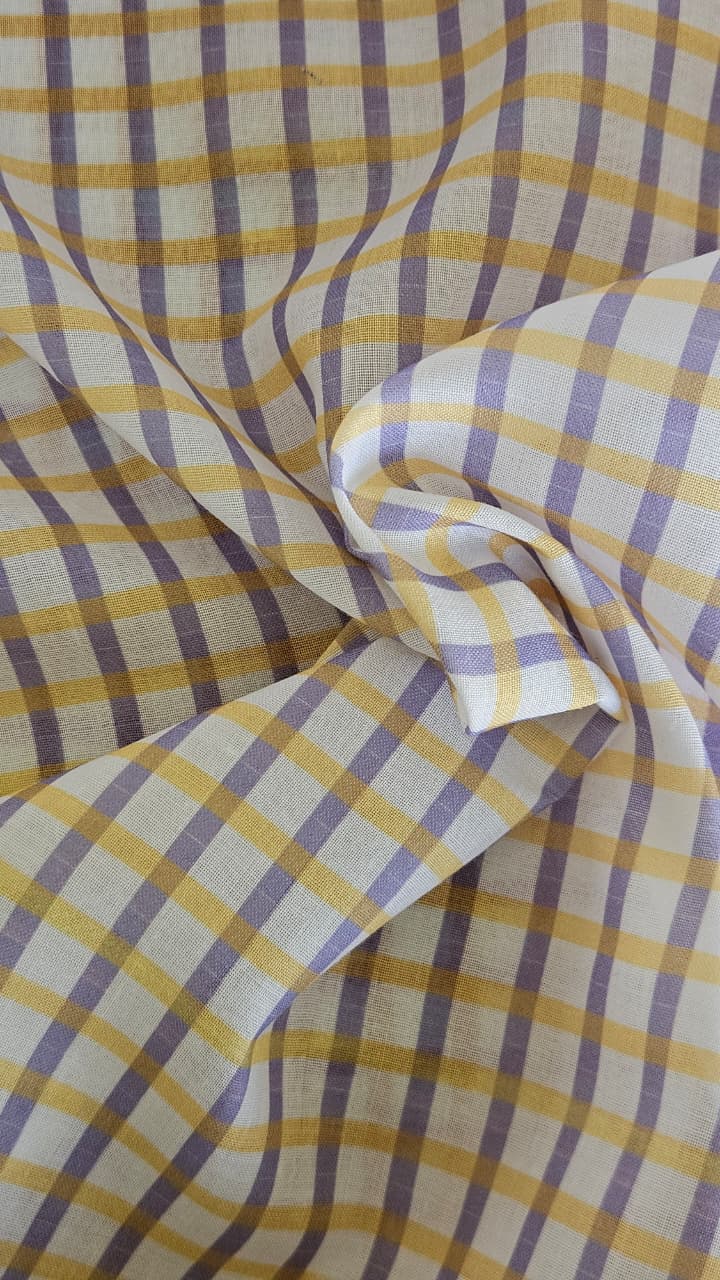 Close-up of soft, wrinkled pink cotton fabric displaying fine weave texture.