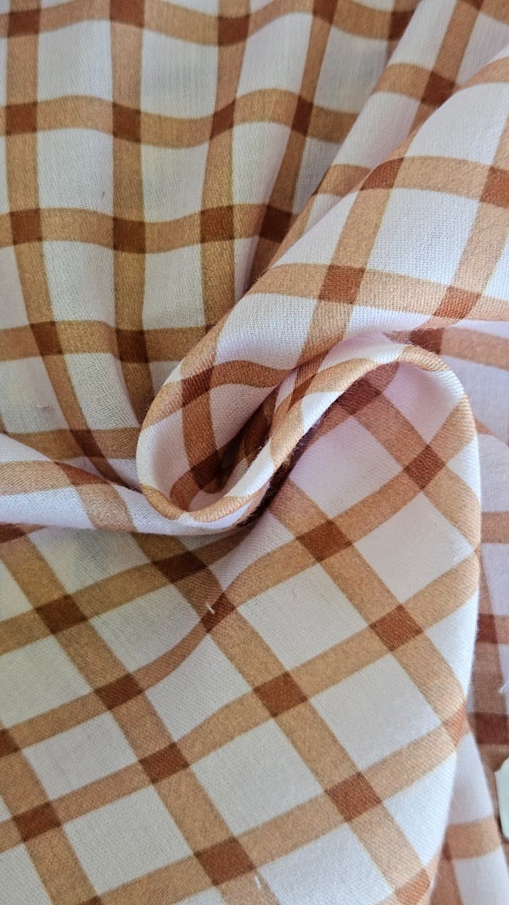 Close-up of soft, wrinkled pink cotton fabric displaying fine weave texture.