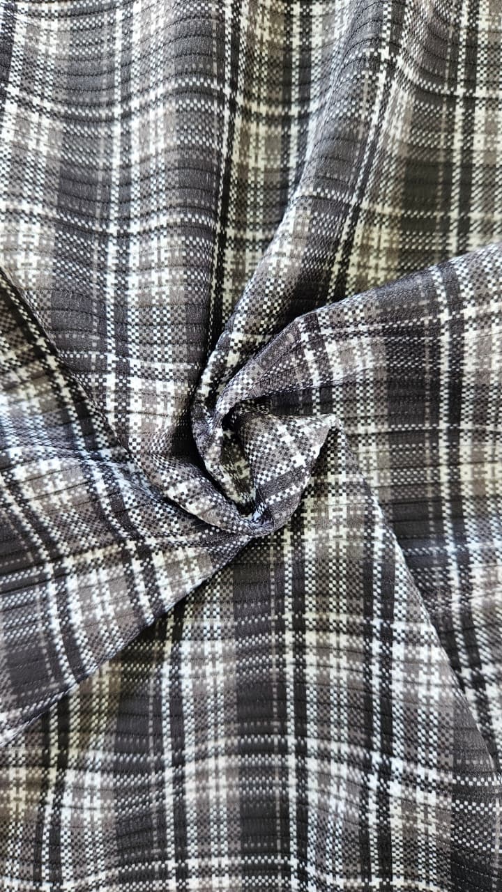 Close-up of soft, wrinkled pink cotton fabric displaying fine weave texture.