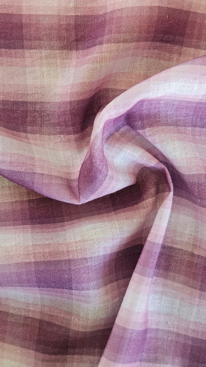 Close-up of soft, wrinkled pink cotton fabric displaying fine weave texture.