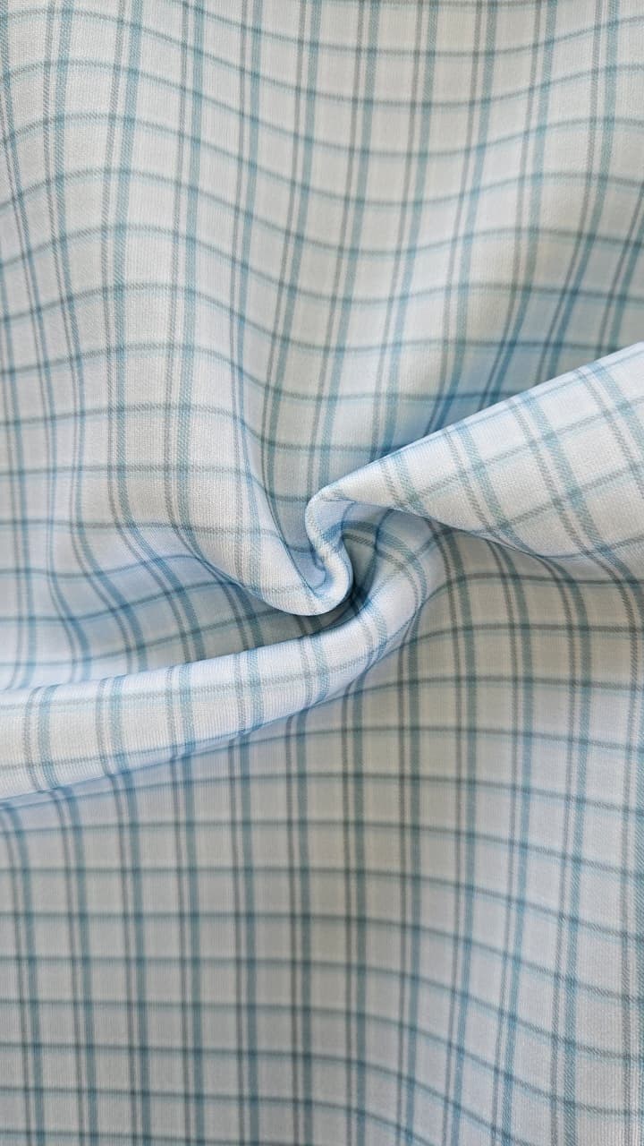 Close-up of soft, wrinkled pink cotton fabric displaying fine weave texture.