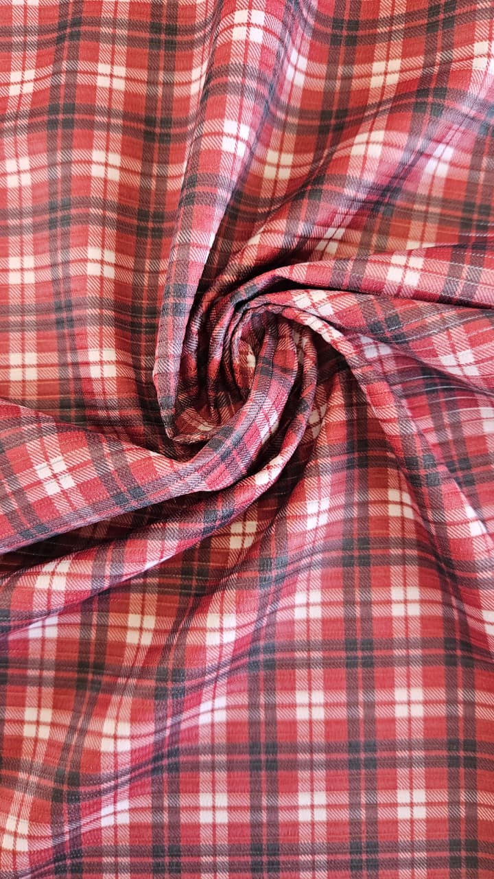 Close-up of soft, wrinkled pink cotton fabric displaying fine weave texture.