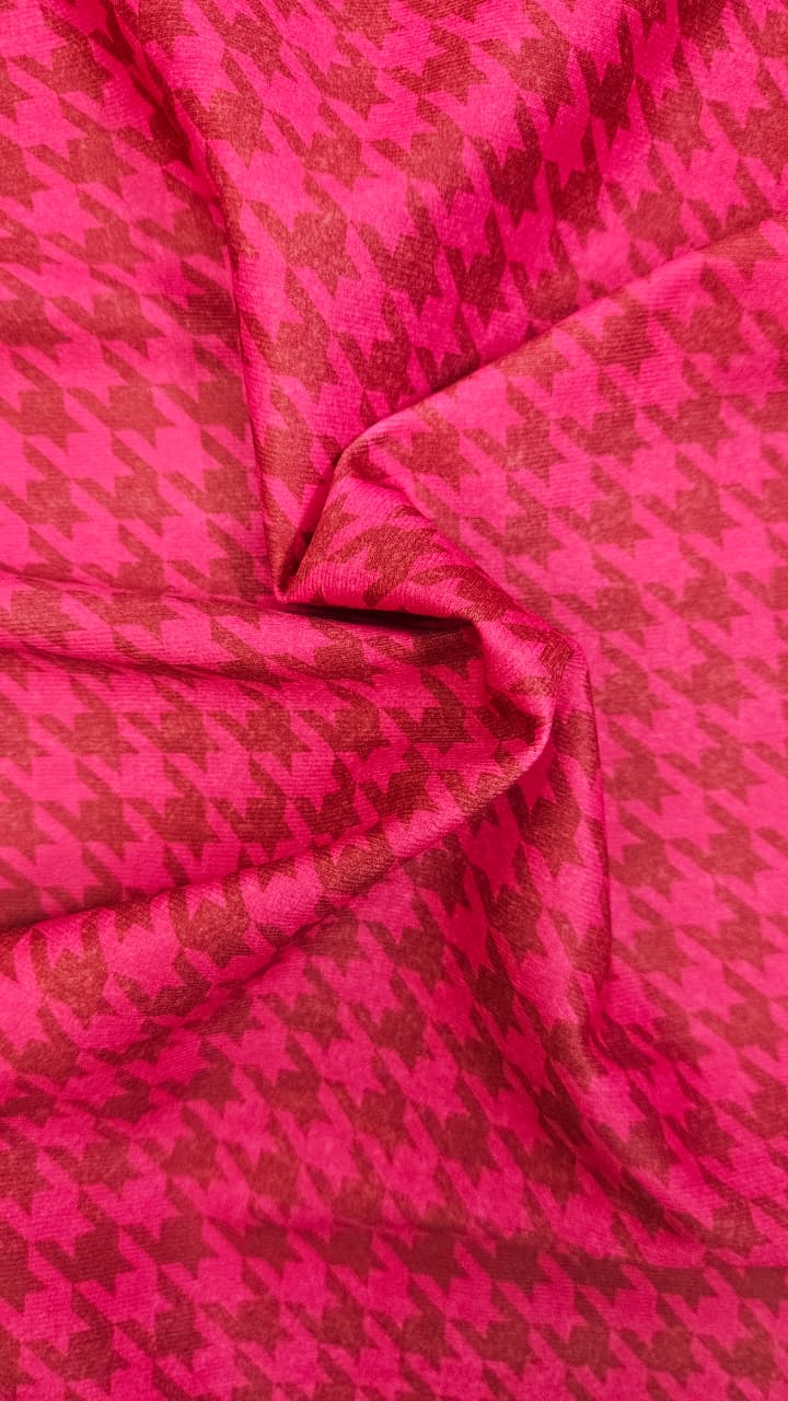 Close-up of soft, wrinkled pink cotton fabric displaying fine weave texture.