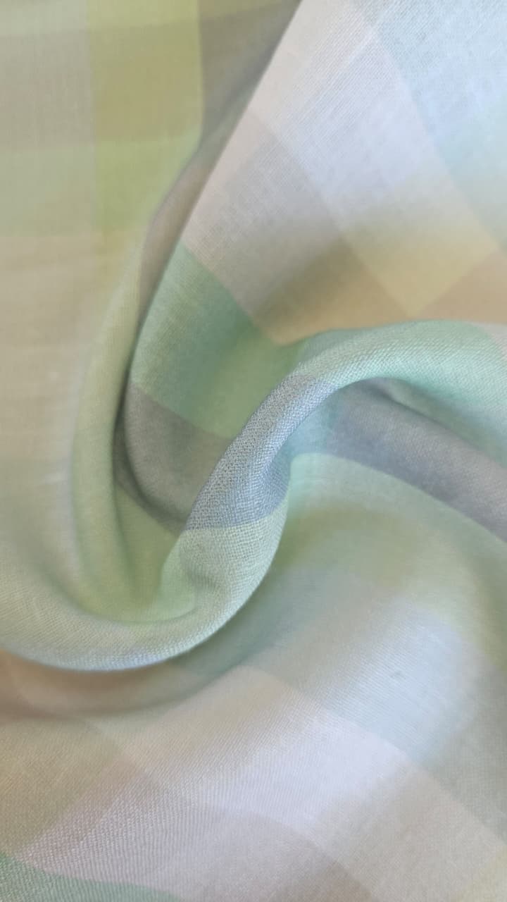 Close-up of soft, wrinkled pink cotton fabric displaying fine weave texture.