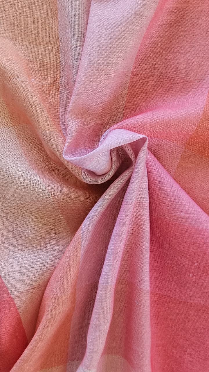 Close-up of soft, wrinkled pink cotton fabric displaying fine weave texture.