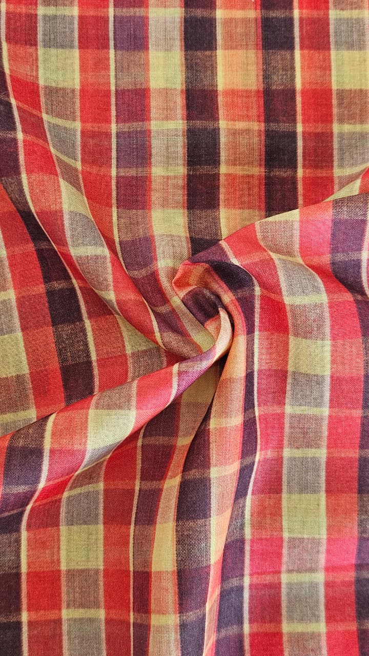 Close-up of soft, wrinkled pink cotton fabric displaying fine weave texture.